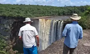 Happy tourists enjoying the view of Kaieteur Falls on a Wilderness Explorers tour.
