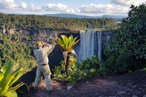 Tourist taking photo of Kaieteur Falls