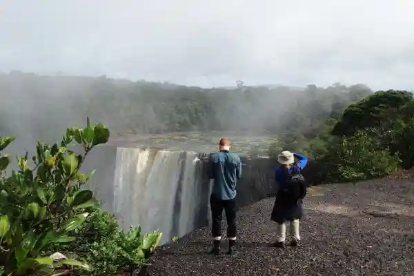 Tourist Capturing the Kaiteur Falls in Rainbow